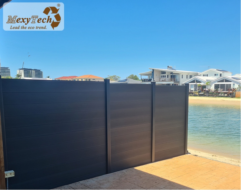 MexyTech black WPC privacy fence beside waterfront patio