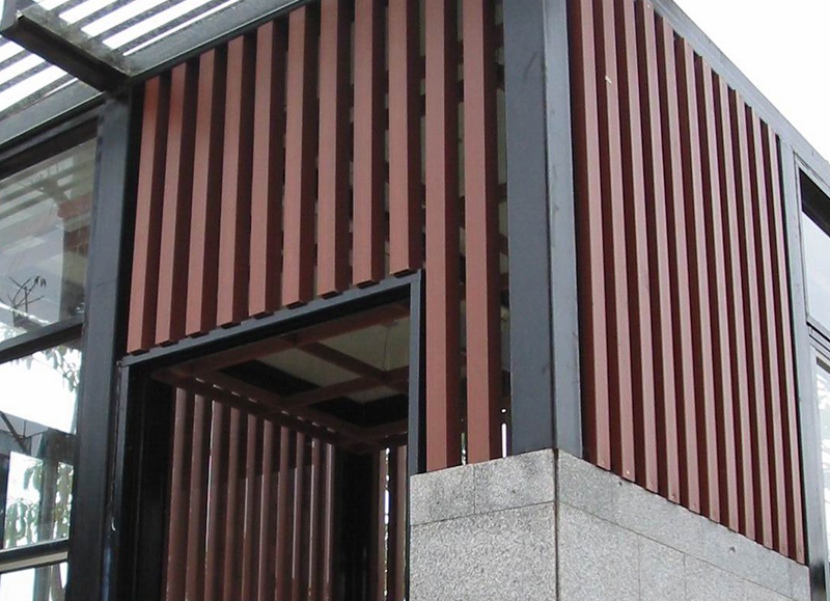 mexytech Composite Wall Cladding exterior application with vertical wood-look slat panels on a modern building facade